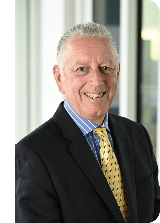 Photo: Ian Robertson smiles. He is weating a smart jacket and a colourful patterned tie.